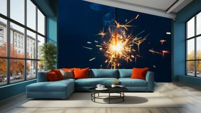 shiny fire sparkler on dark blue background Wall mural