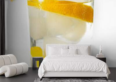 Glass of cold fresh water with slices of ice and lemon. Wall mural