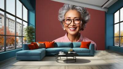 Smiling Asian woman with gray hair and stylish casual clothes. Wall mural