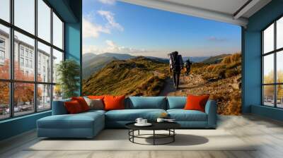 Three young tourists, two little boys and a teenager walk the trails of the Montenegrin ridge, around the top of the Carpathian mountains. Wall mural