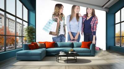 Group of three happy young adult women out of shopping with colorful bags Wall mural