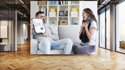 Young couple showing love message written on white board. I love you message. Valentines couple,shallow depth of filed Wall mural