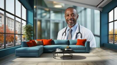 Portrait of a smiling middle aged male doctor in hospital Wall mural