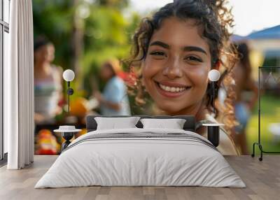 Portrait of a smiling young woman attending a barbecue Wall mural