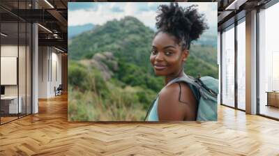 Portrait of a young black woman hiking in beautiful scenery during summer Wall mural