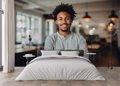 Smiling portrait of a happy young african american man working in a modern startup company in a business office Wall mural