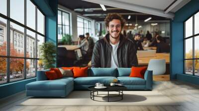 Smiling portrait of a happy young caucasian man working for a modern startup company in a business office Wall mural