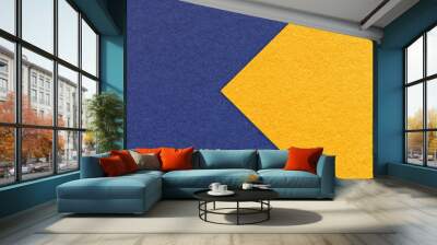 Texture of navy blue paper background, half two colors with yellow arrow, macro. Craft denim and golden cardboard. Wall mural