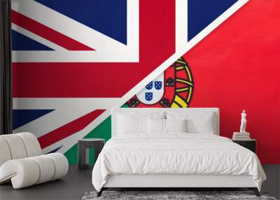 United Kingdom vs Portugal national flag from textile. Relationship between two european countries. Wall mural