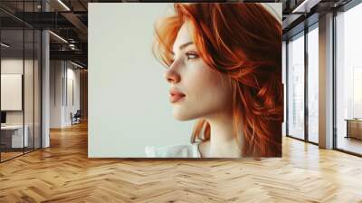 A woman with copper-colored red hair on a light background. Wall mural