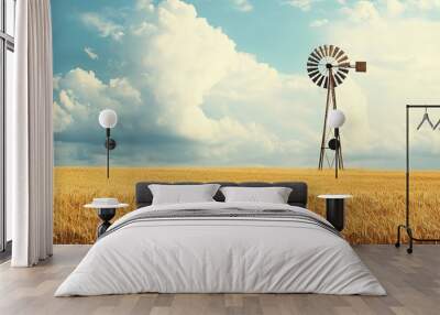 Rustic windmill in golden wheat field under blue sky Wall mural