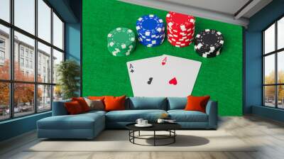 Casino chips and playing cards on green table Wall mural