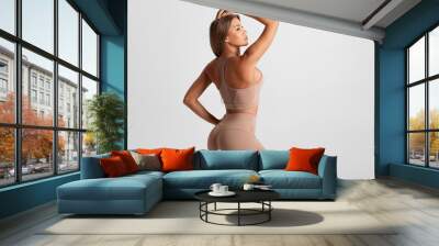 Fitness woman. Athletic girl on the gray background Wall mural