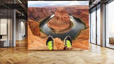 Legs of traveler man sitting on the background of the canyon Horseshoe bend, Arizona, USA. Travel concept, scenic view Wall mural