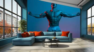 Muscular man showing muscles. Strong male naked torso abs Wall mural