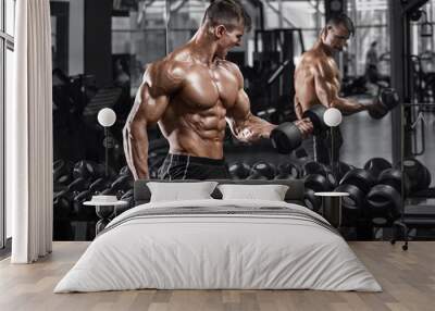 Muscular man working out in gym doing exercises, strong male naked torso abs Wall mural