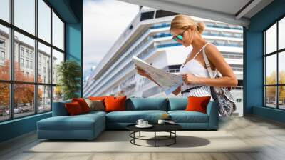 Woman tourist with map, standing in front of big cruise liner, travel female Wall mural