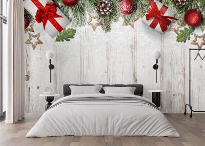 Frosty Christmas decorations and gifts covered with snowflakes on white wooden background. Christmas background with free space for text Wall mural