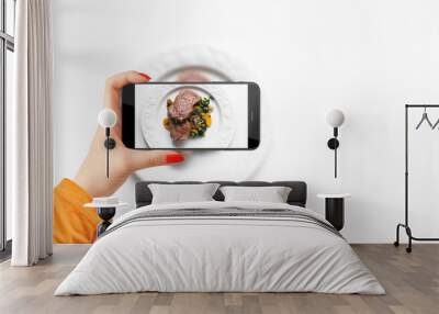 Girl takes a photo of her meal with smartphone for her social media Wall mural