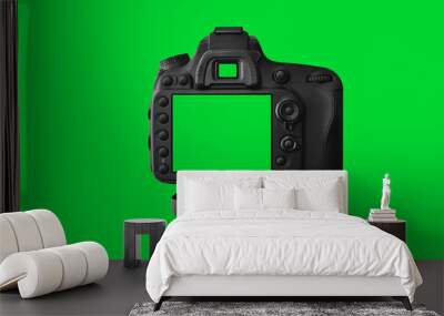 The Dslr camera with empty screen on the tripod, isolated on green background. The chromakey. Green screen. Wall mural