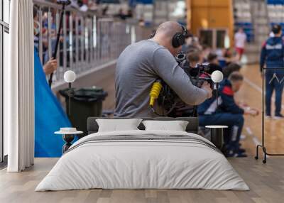 Videographer filming a sporting Wall mural