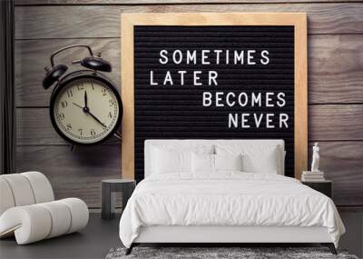 Inspirational motivational quote Sometimes later becomes never. Do it now words on a letter board on wooden background near vintage alarm clock. Success and motivation concept. Wall mural