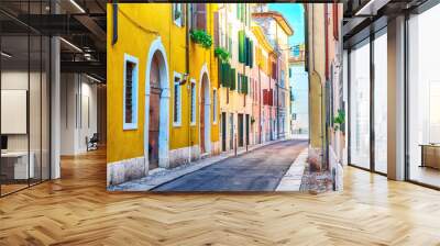 Old town cozy narrow street view with colorful houses in Verona, Italy during sunny day. Wall mural