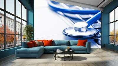 Top view of professional stethoscope with modern silver laptop. Telemedicine concept. Blue toned. Wall mural