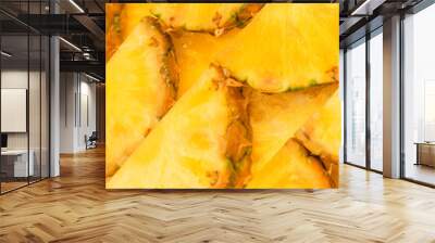 Pineapple juicy yellow slices as a background. Wall mural