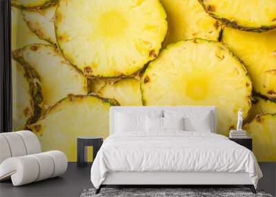 Pineapple juicy yellow slices background. Top view. Wall mural