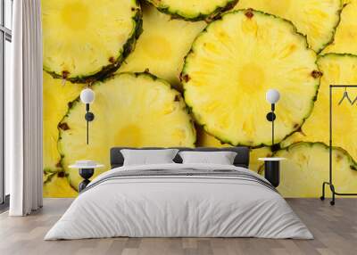 Pineapple juicy yellow slices background. Top view. Wall mural