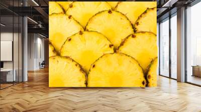 Pineapple juicy yellow slices background. Top view. Wall mural