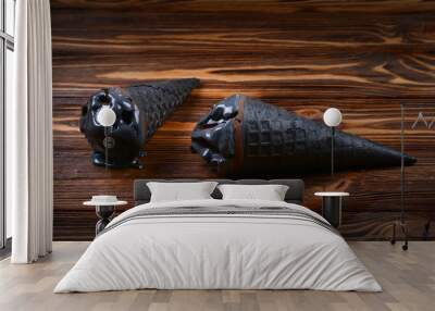 Trendy black ice cream in traditional portioned ice cream cones. On a brown wooden table. Copy space Wall mural