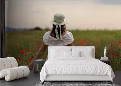 Woman in a white dress posing in a poppy garden Wall mural