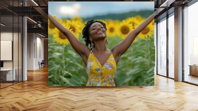 A beautiful mixed-race woman with her arms raised in joy, standing... Wall mural