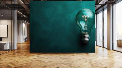 Artistic lightbulb on a deep green background, clear space for adding your own text Wall mural