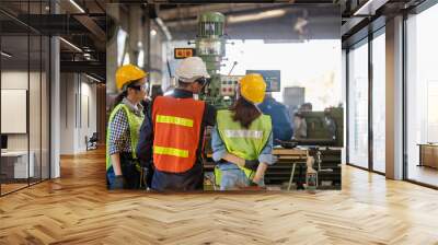 Asian Group industrial manager man demonstration and training mechanic worker woman  operating industrial lathe machine. Industry and engineering people technology concept . Wall mural