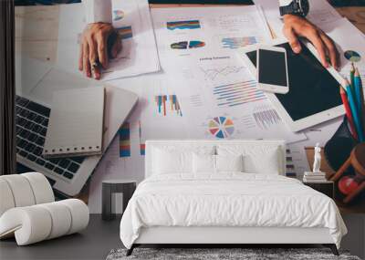 businessman hand working on laptop computer with financial business graph Wall mural