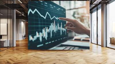 Modern office setup with a hand pointing to a success arrow on a financial chart Wall mural