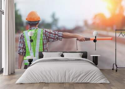 Worker with light stick on road construction background Wall mural