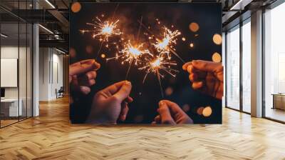 A close-up shot of several hands holding lit sparklers Wall mural