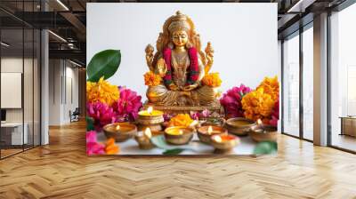 colourful and beautiful lord Laxmi statue sits on a table surrounded by flowers and candles Wall mural