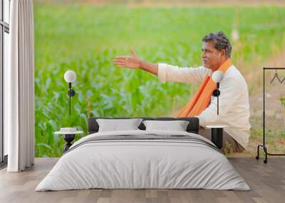 Indian farmer at green corn field Wall mural