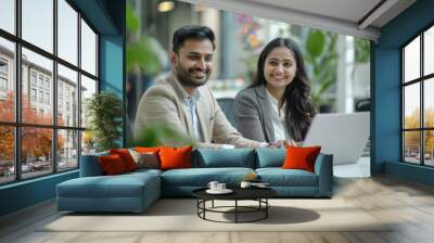 indian man and woman using laptop at office Wall mural