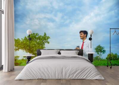 Indian man enjoys in nature with binoculars Wall mural