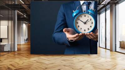 man in suit holding clock Wall mural