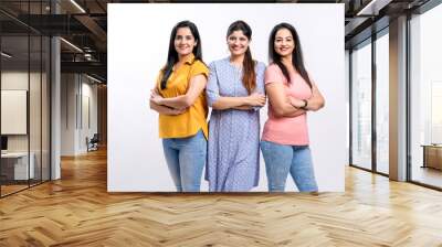 Three indian women giving expression together on white background. Wall mural