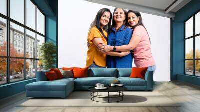 Three indian women giving expression together on white background. Wall mural