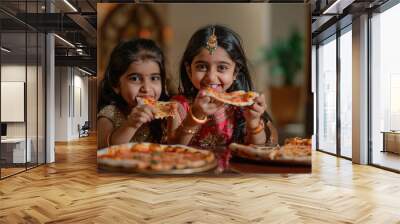 two indian little girls eating pizza at home Wall mural