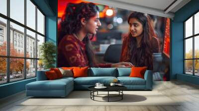 two young indian female talking to each other at computer lab Wall mural